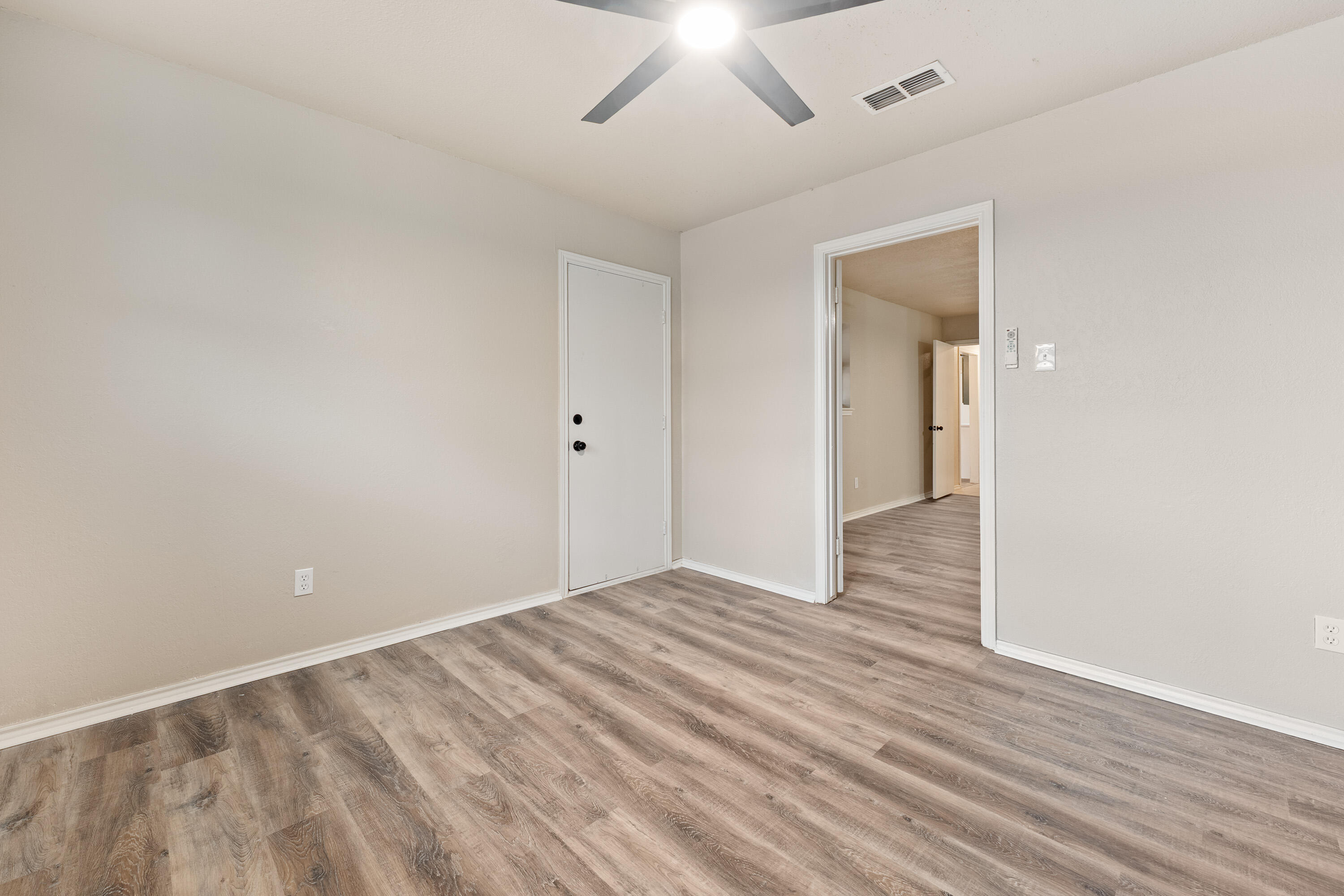 7902 Lynnhaven Avenue Lubbock, TX 79423 - Photo 27 of 35 a view of an empty room with wooden floor