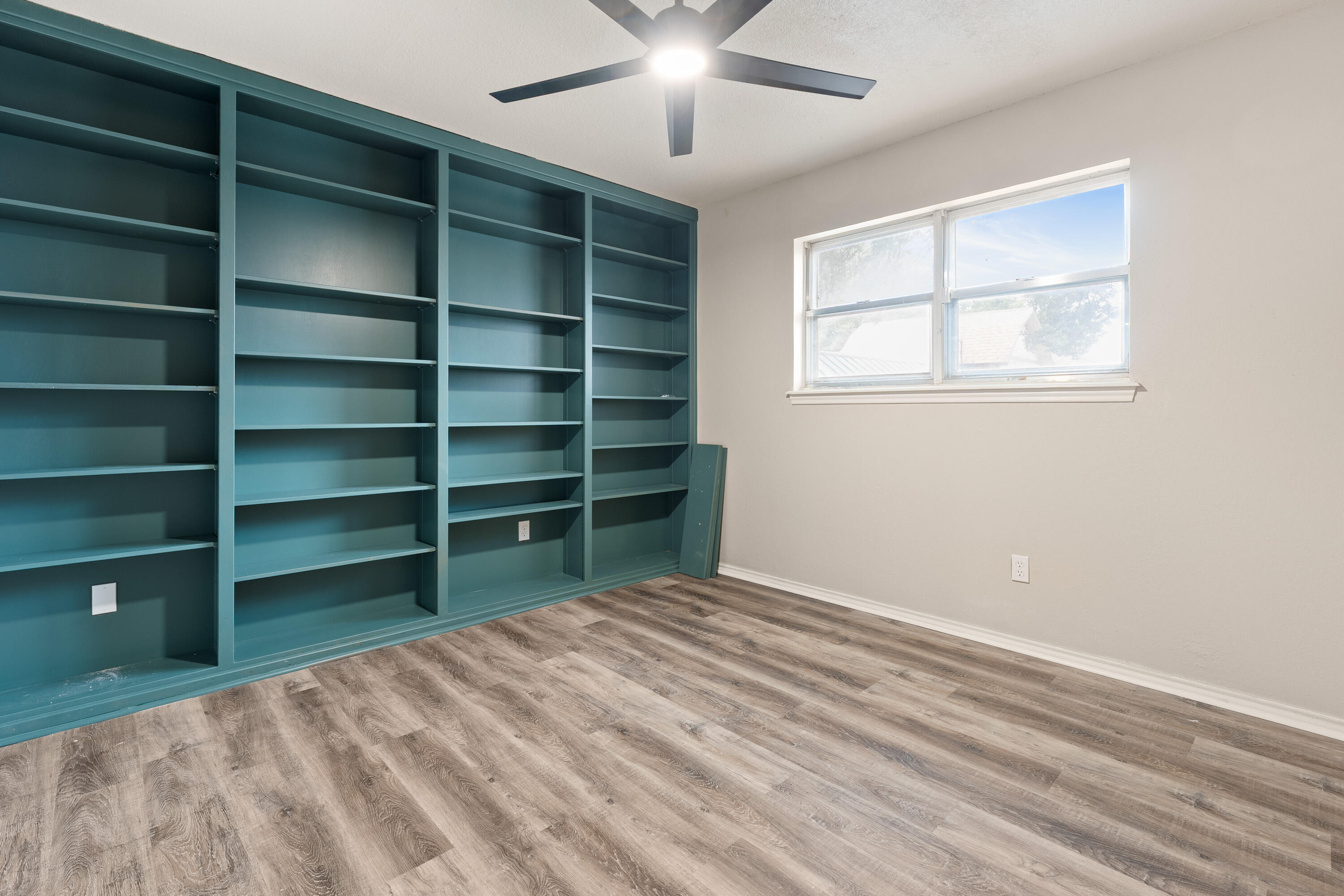 7902 Lynnhaven Avenue Lubbock, TX 79423 - Photo 30 of 35 a view of a room with empty cabinets and a window