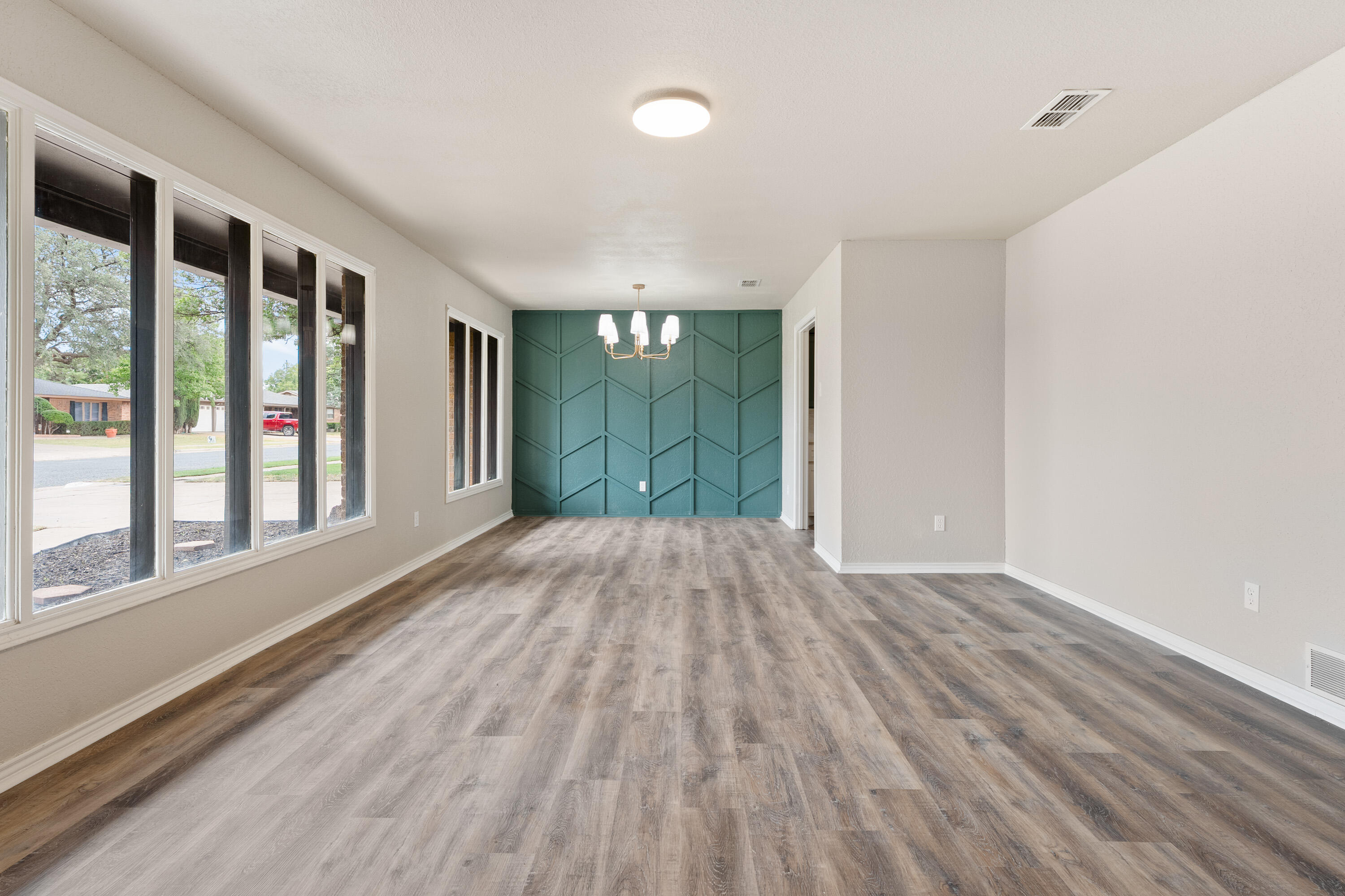 7902 Lynnhaven Avenue Lubbock, TX 79423 - Photo 4 of 35 wooden floor in an empty room with a window