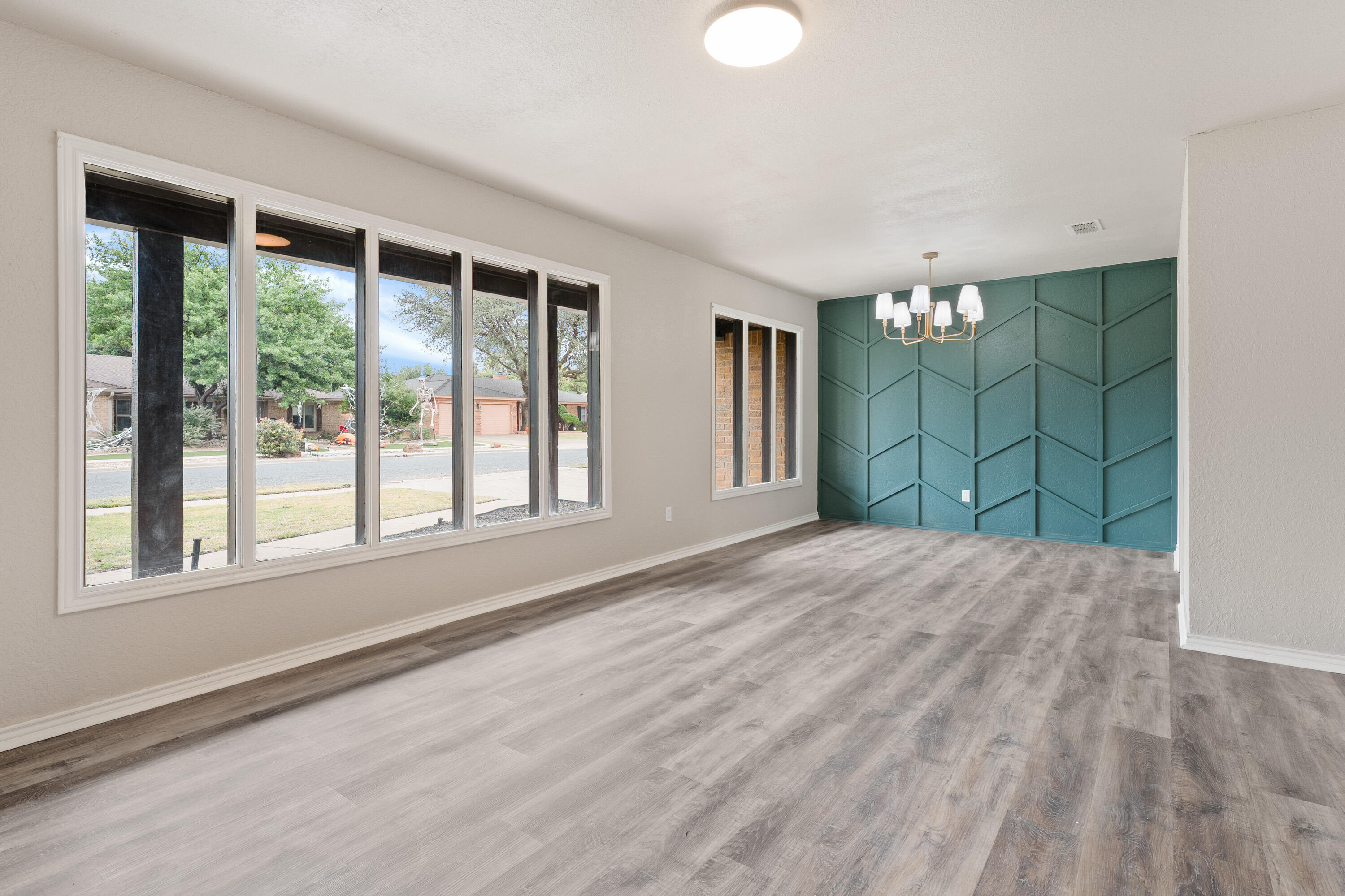 7902 Lynnhaven Avenue Lubbock, TX 79423 - Photo 5 of 35 a view of empty room with floor to ceiling window and room