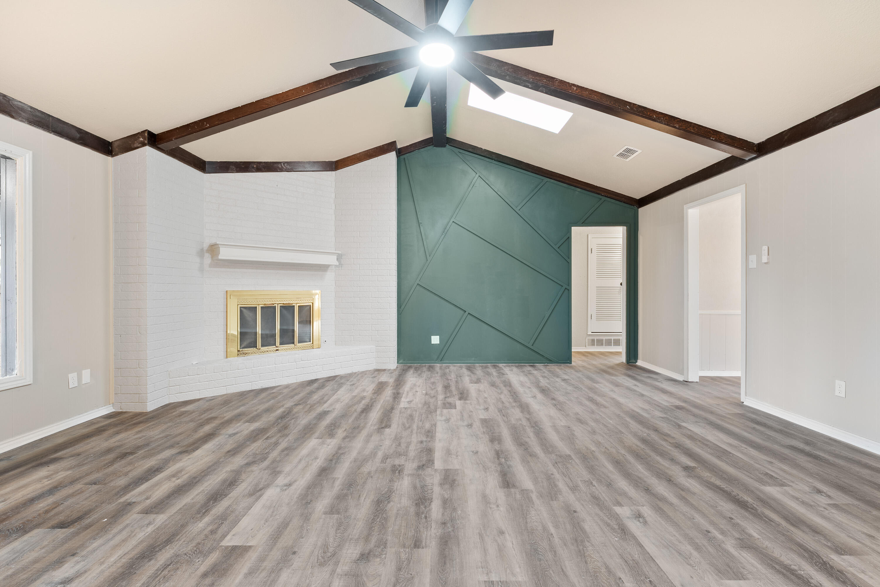 7902 Lynnhaven Avenue Lubbock, TX 79423 - Photo 7 of 35 a view of an empty room with a window and wooden floor