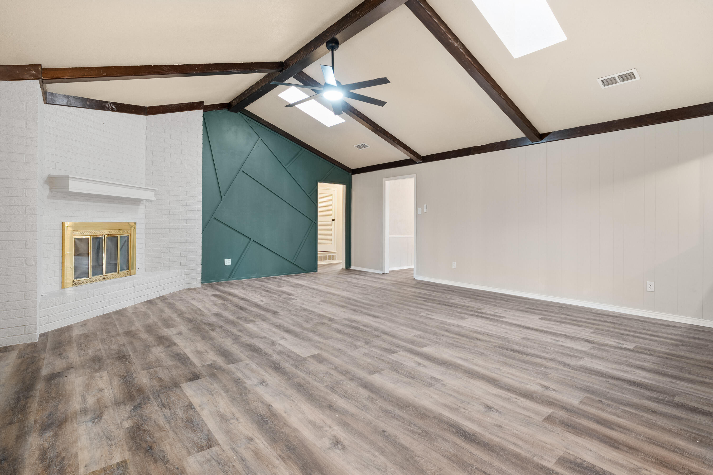 7902 Lynnhaven Avenue Lubbock, TX 79423 - Photo 8 of 35 a view of empty room with wooden floor and fan