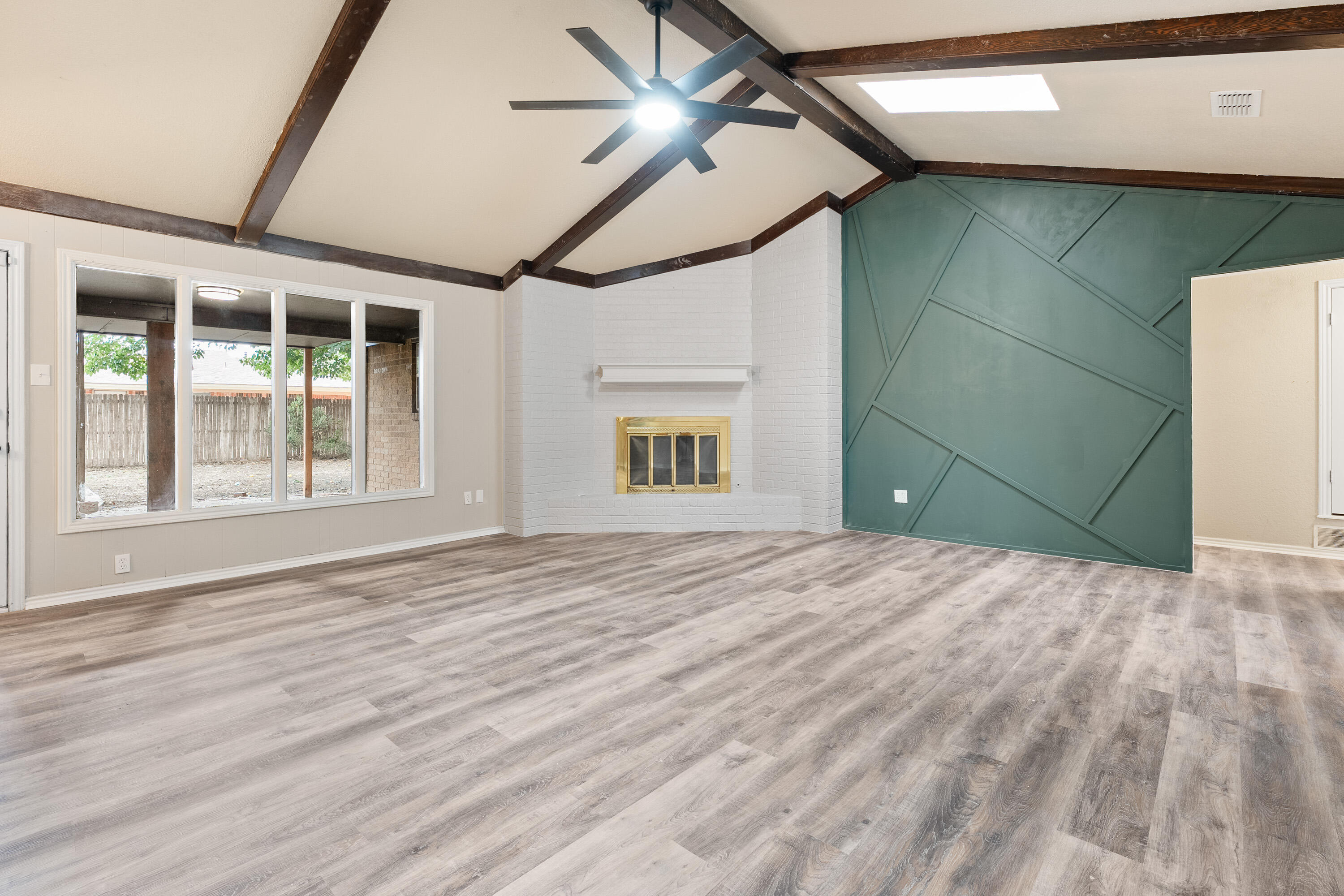 7902 Lynnhaven Avenue Lubbock, TX 79423 - Photo 9 of 35 a view of empty room with wooden floor and fan