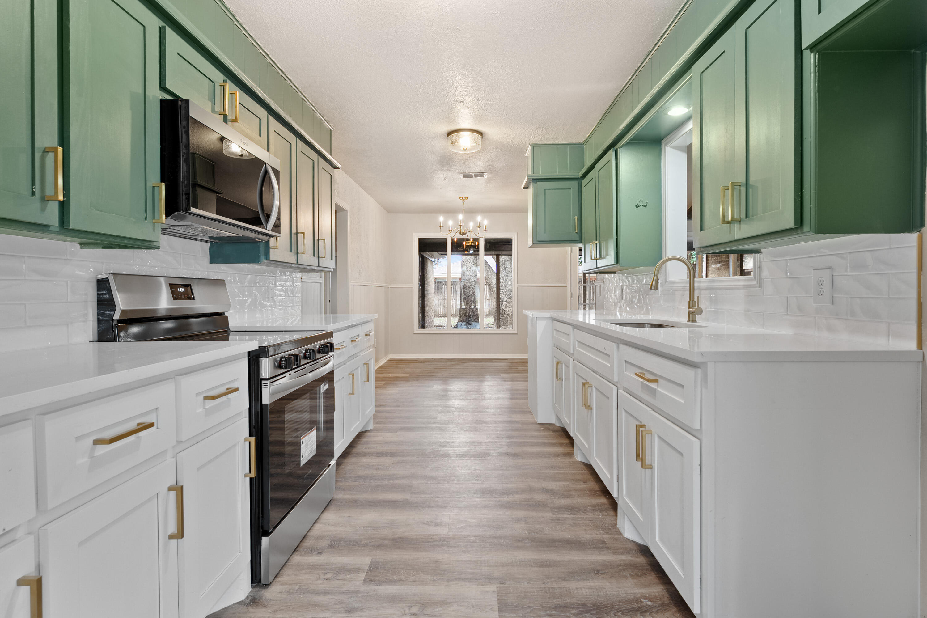 7902 Lynnhaven Avenue Lubbock, TX 79423 - Photo 10 of 35 a large white kitchen with stainless steel appliances