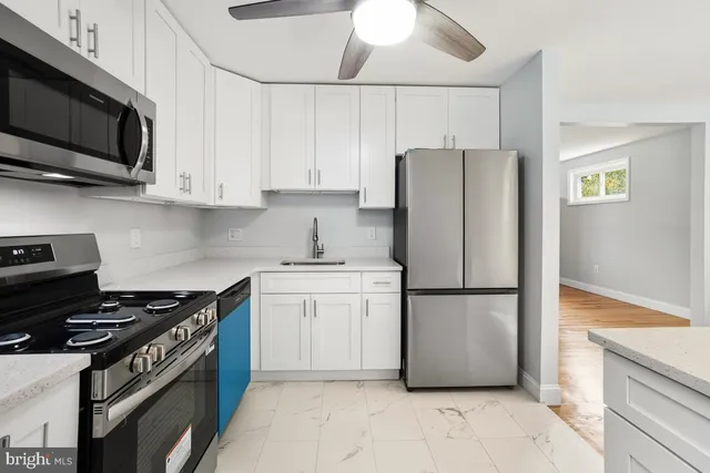 a kitchen with a refrigerator stove and microwave