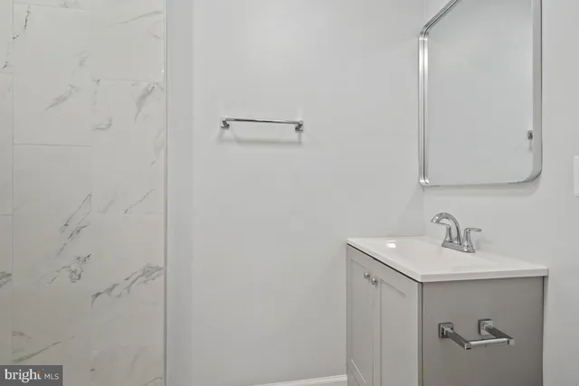 a bathroom with a sink and mirror