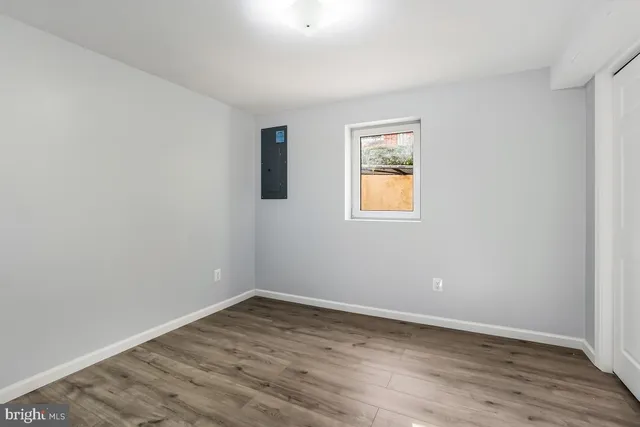 wooden floor in an empty room with a window