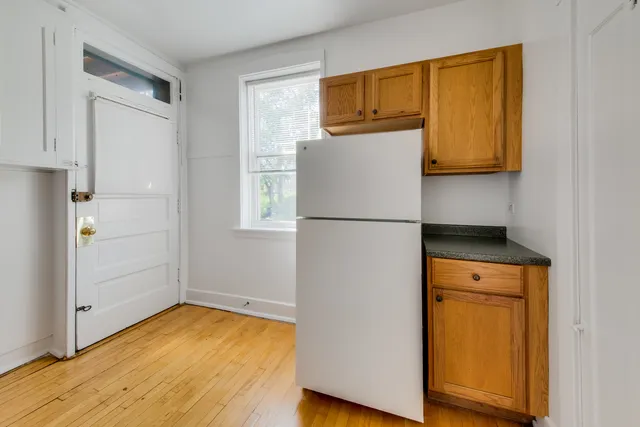 a kitchen with a refrigerator and a stove