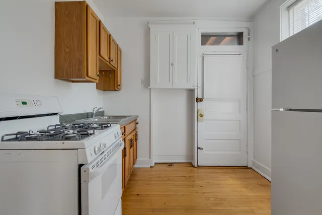 a kitchen with stainless steel appliances granite countertop a stove and a refrigerator