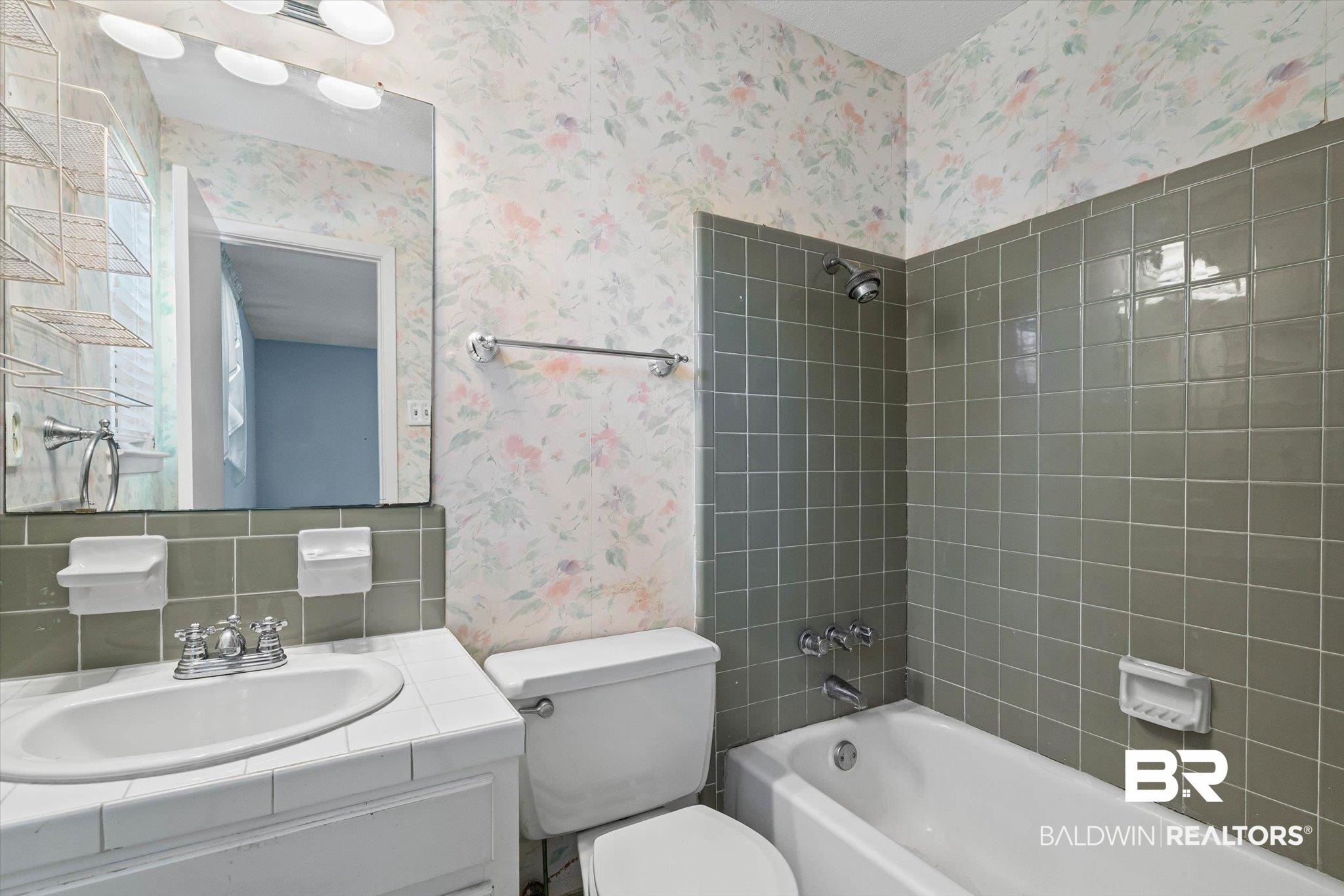 6300 Christopher Drive North Mobile, AL 36609 - Photo 12 of 22 Bathroom featuring wallpapered walls, tub / shower combination, vanity, and decorative backsplash