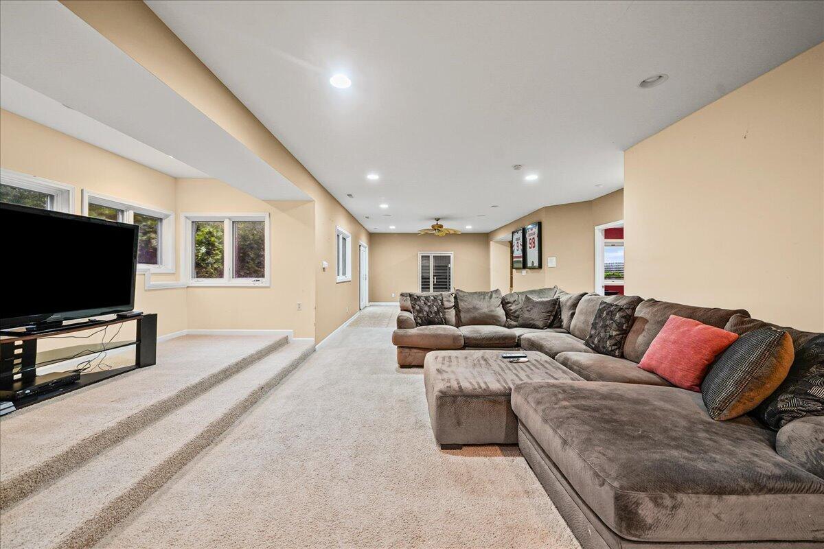 8751 Bridgewater Court Crown Point, IN 46307 - Photo 45 of 49 a living room with furniture and a flat screen tv