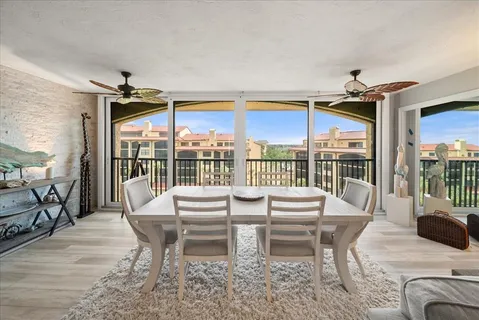 a dining room with furniture and wooden floor