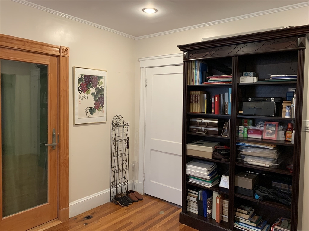 23 Lafayette Street, Unit 23 Arlington, MA 02474 - Photo 11 of 18 a view of a bedroom with workspace and wooden floor