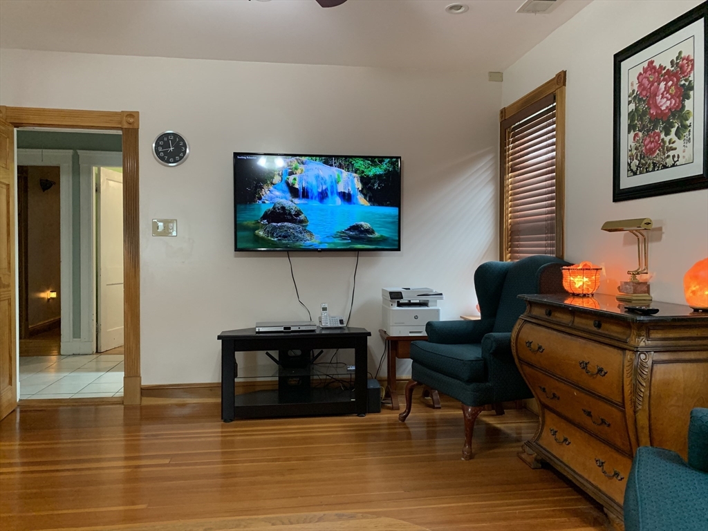 23 Lafayette Street, Unit 23 Arlington, MA 02474 - Photo 12 of 18 a living room with furniture and a flat screen tv