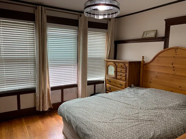 a bedroom with a bed and a chandelier