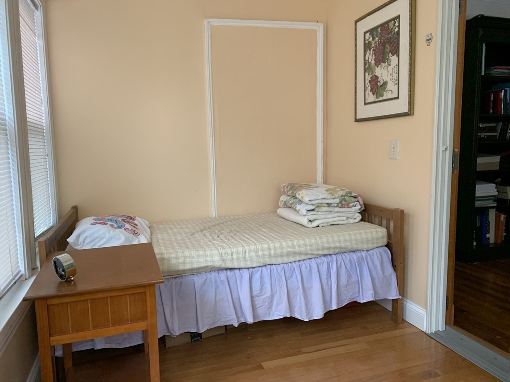 23 Lafayette Street, Unit 23 Arlington, MA 02474 - Photo 9 of 18 a bedroom with a bed and a window