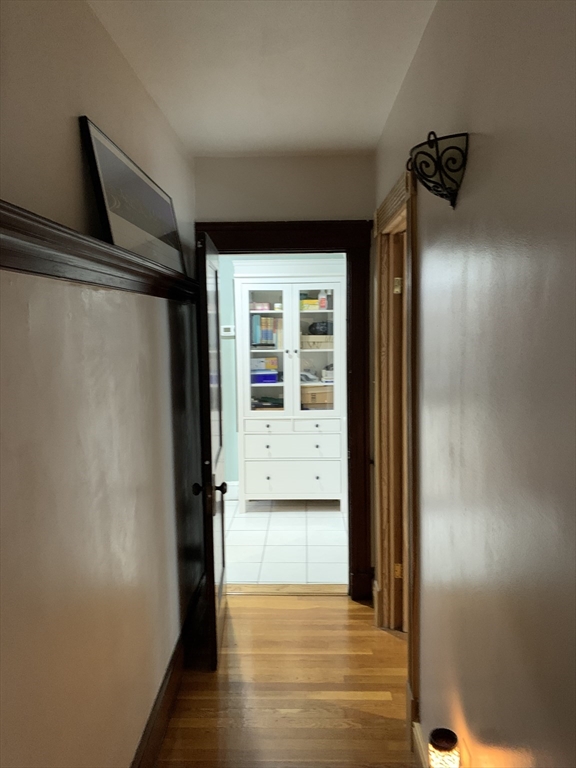 23 Lafayette Street, Unit 23 Arlington, MA 02474 - Photo 10 of 18 a view of a hallway with wooden floor and a room