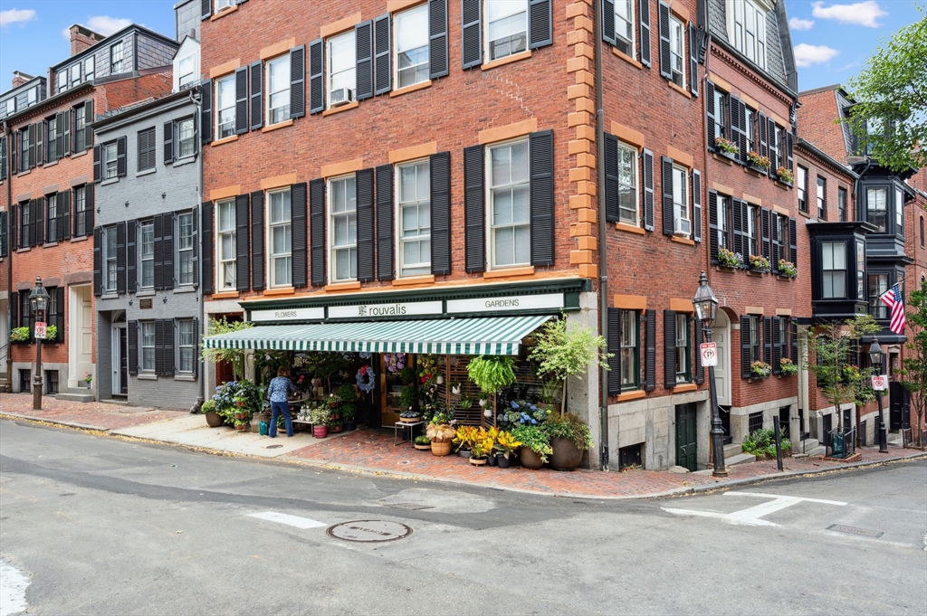 5 Grove Street, Unit 9 Boston, MA 02114 - Photo 22 of 24 a view of a building and a street