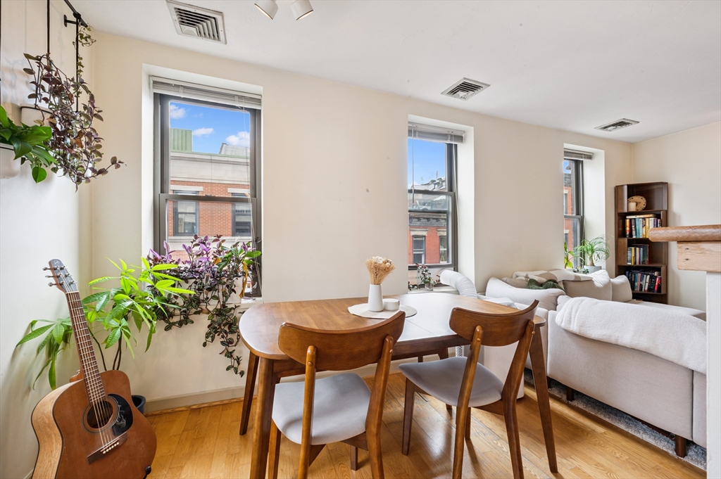 5 Grove Street, Unit 9 Boston, MA 02114 - Photo 6 of 24 a view of a dining room with furniture and wooden floor