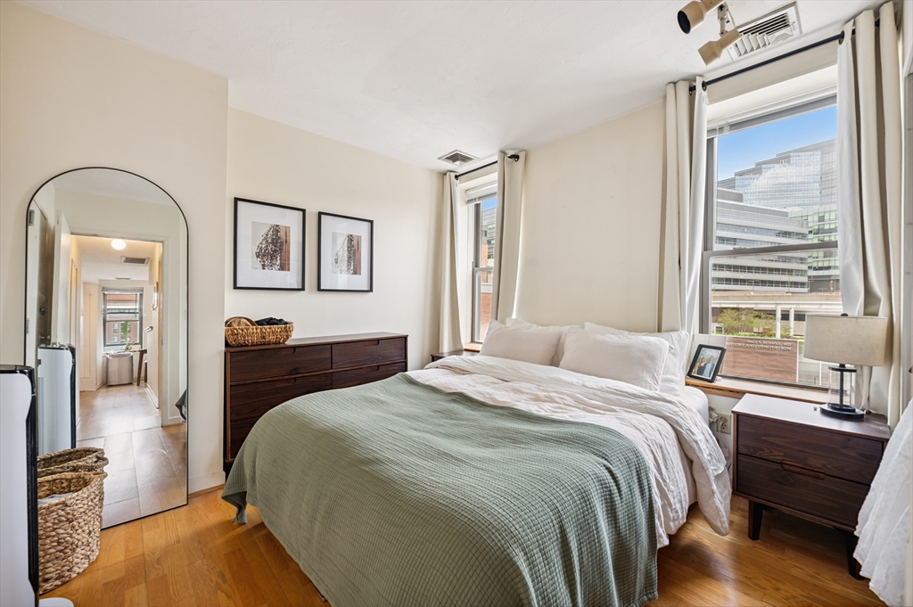 5 Grove Street, Unit 9 Boston, MA 02114 - Photo 10 of 24 a bedroom with a bed and wooden floor