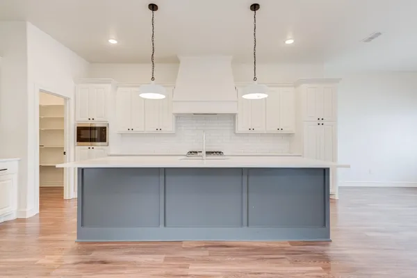 a kitchen with stainless steel appliances granite countertop a sink a refrigerator and a stove