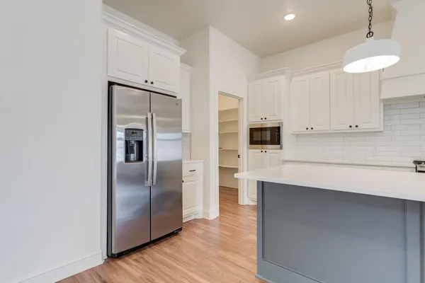 a kitchen with stainless steel appliances a refrigerator and cabinets