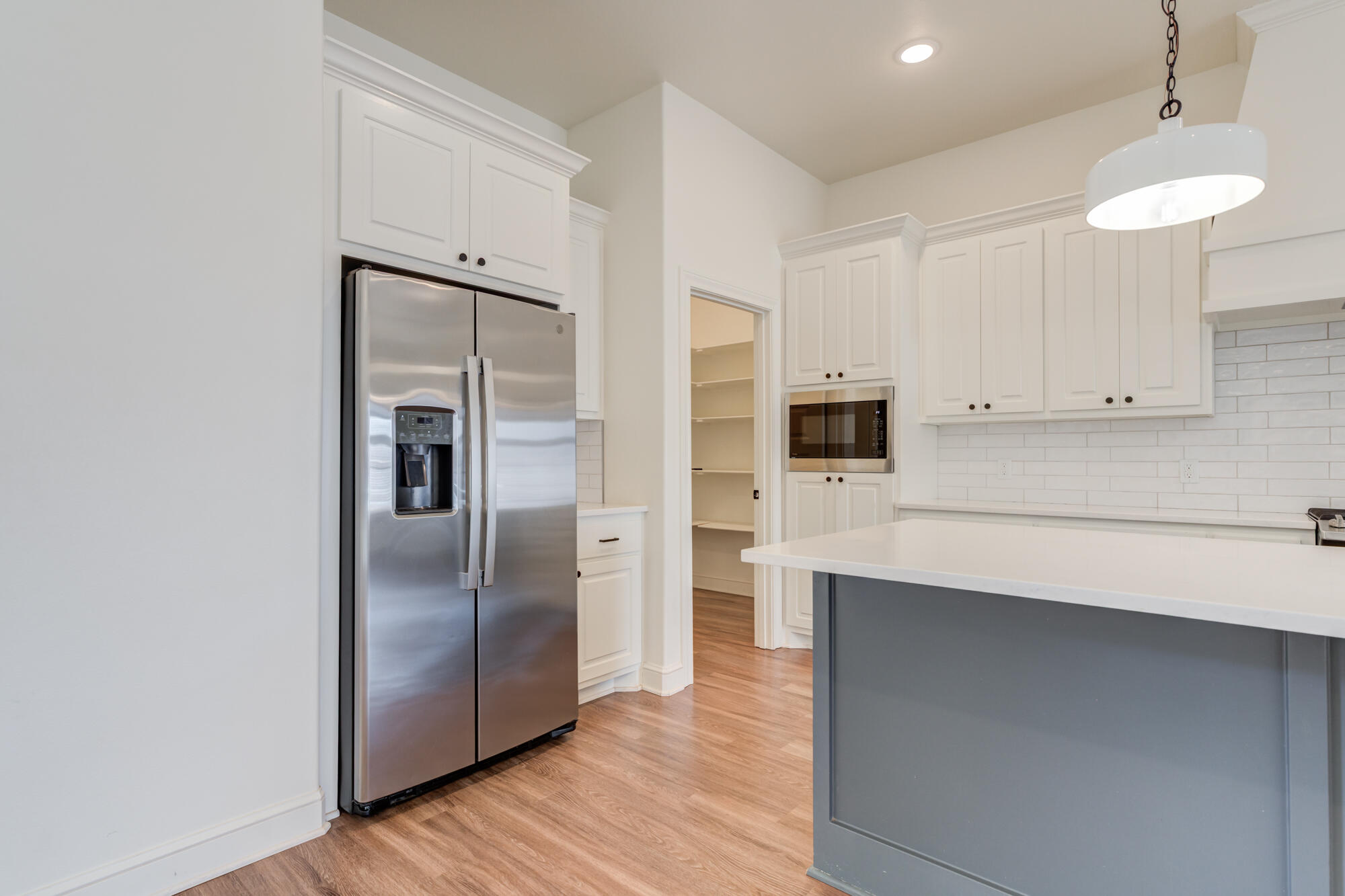 7603 52nd Street Lubbock, TX 79407 - Photo 16 of 46 a kitchen with stainless steel appliances a refrigerator and cabinets