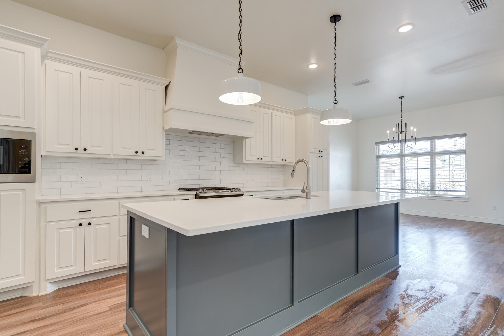 7603 52nd Street Lubbock, TX 79407 - Photo 17 of 46 a kitchen with kitchen island a sink stainless steel appliances and cabinets