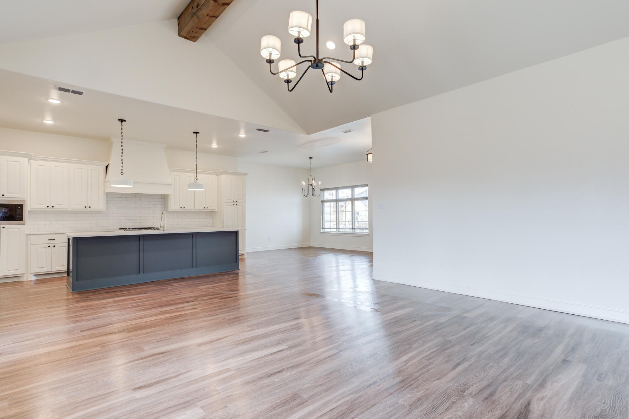 7603 52nd Street Lubbock, TX 79407 - Photo 25 of 46 a view of a kitchen with a dishwasher a kitchen island hardwood floor and a sink