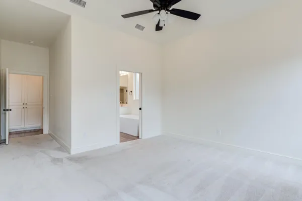 a view of a room with a ceiling fan