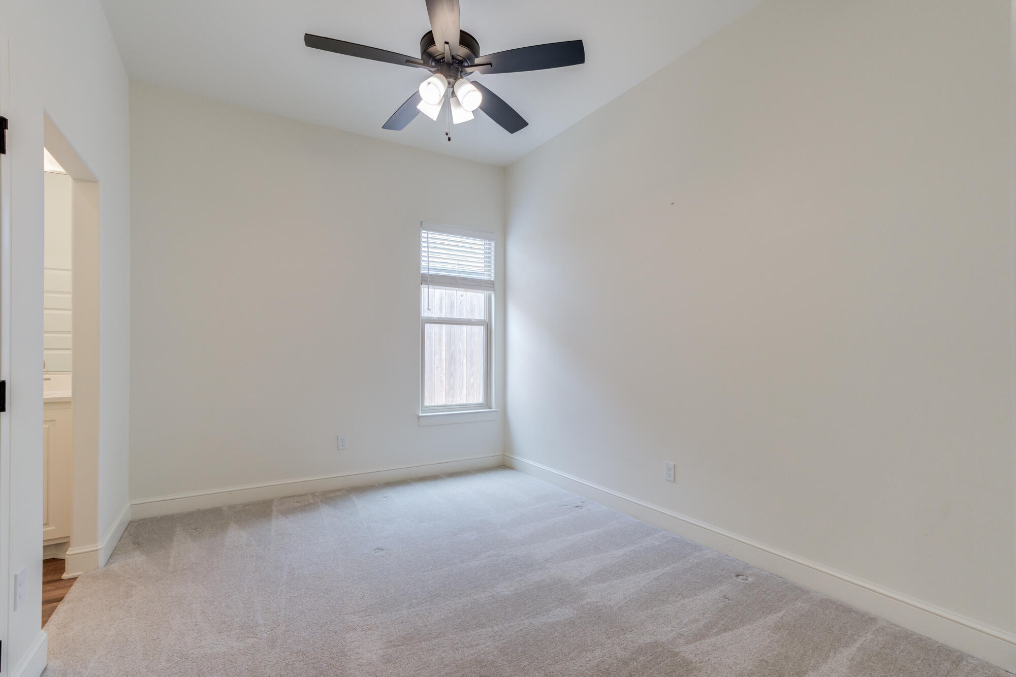 7603 52nd Street Lubbock, TX 79407 - Photo 33 of 46 an empty room with windows and fan