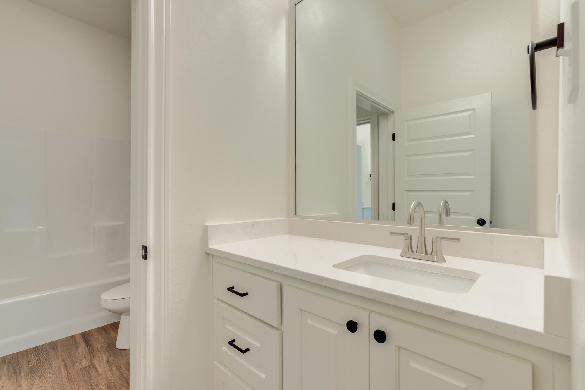 7603 52nd Street Lubbock, TX 79407 - Photo 35 of 46 a bathroom with a sink toilet double vanity and tub