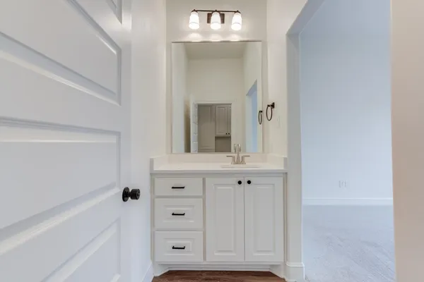 a bathroom with a sink vanity and mirror