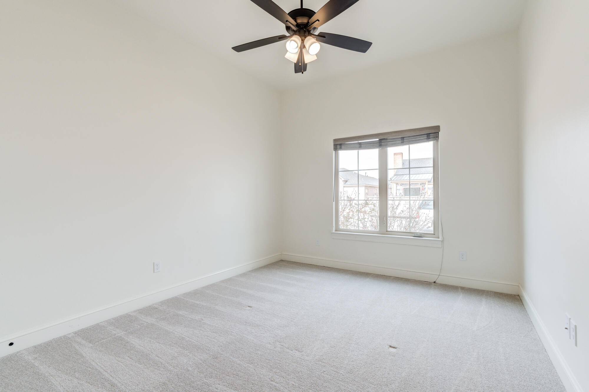 7603 52nd Street Lubbock, TX 79407 - Photo 40 of 46 an empty room with a window and a fan