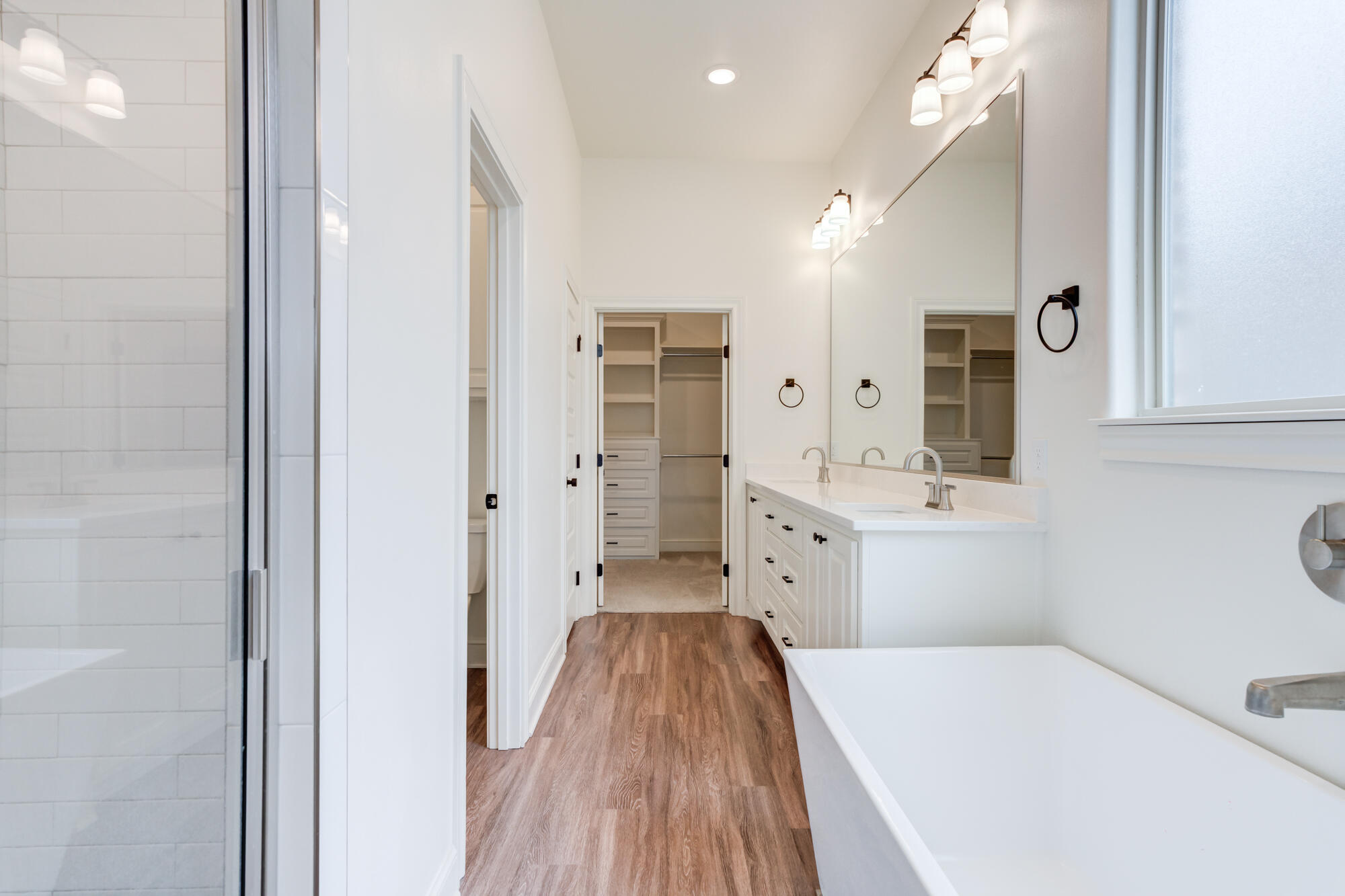 7603 52nd Street Lubbock, TX 79407 - Photo 4 of 46 a bathroom with a sink a toilet a mirror and shower
