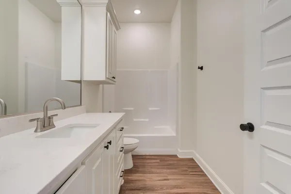 a bathroom with a sink a mirror and a bathtub