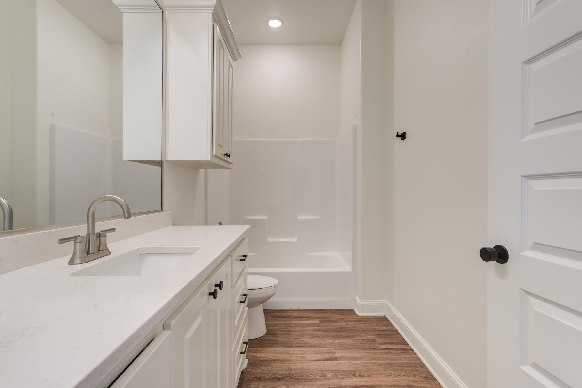 7603 52nd Street Lubbock, TX 79407 - Photo 42 of 46 a bathroom with a sink a mirror and a bathtub