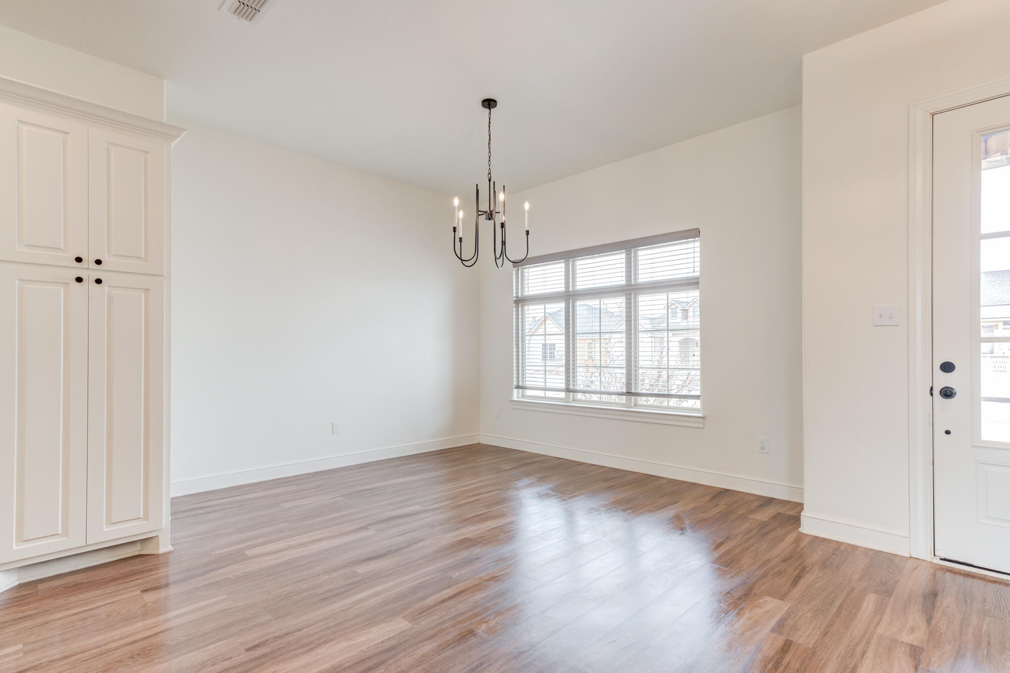 7603 52nd Street Lubbock, TX 79407 - Photo 10 of 46 wooden floor in an empty room with a window