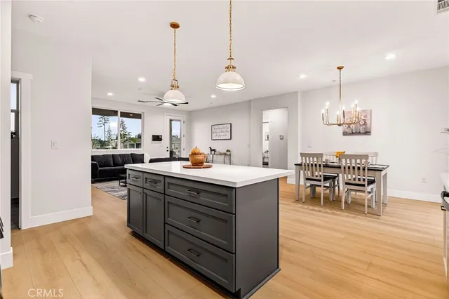 a kitchen with stainless steel appliances granite countertop a stove and a wooden floors