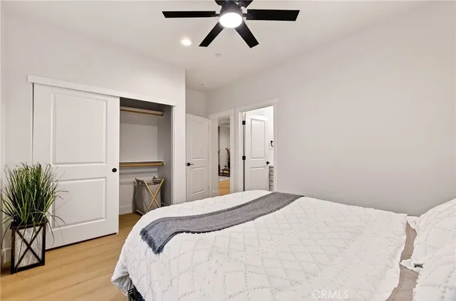 a bedroom with a bed and a potted plant