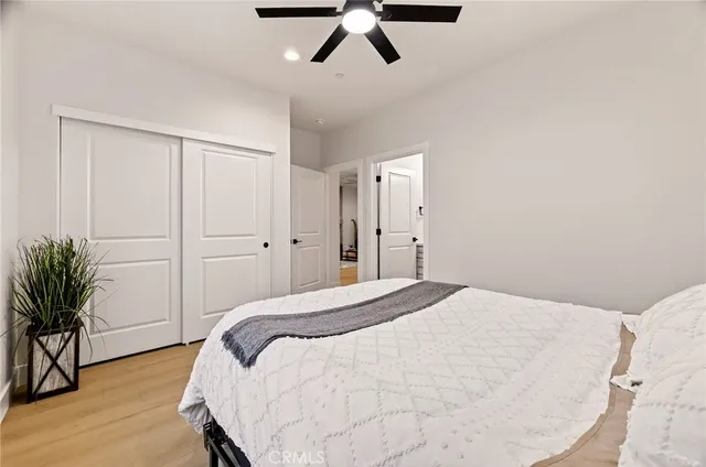 a bedroom with a bed and a potted plant