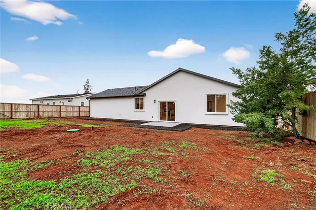 a view of a backyard with a large tree