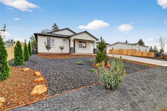a front view of a house with a yard and a garage