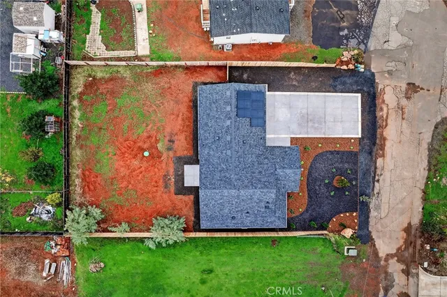 an aerial view of a house with a yard