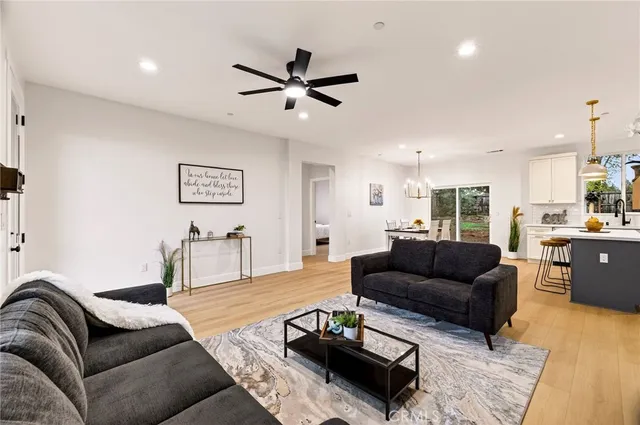 a living room with furniture and a view of kitchen