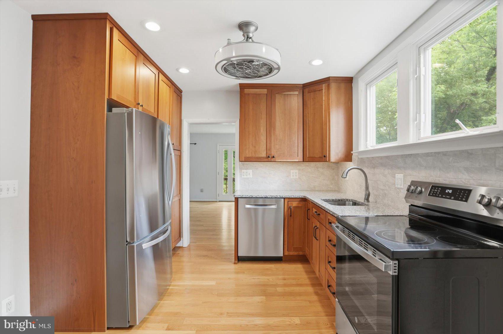 24 Normal Terrace Baltimore, MD 21286 - Photo 11 of 37 a kitchen with stainless steel appliances granite countertop a sink a stove and a refrigerator