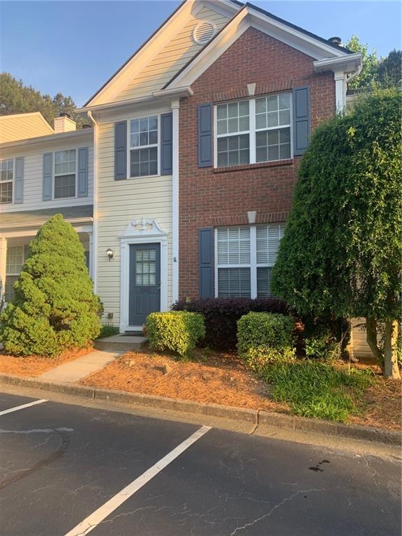 2065 Whitestone Place Alpharetta, GA 30005 - Photo 1 of 1 a front view of a house with a yard and garage