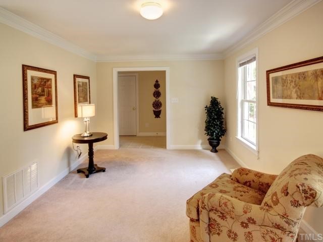 6625 Coach Light Circle Raleigh, NC 27613 - Photo 2 of 12 Formal living room is light and bright and is located off the entry foyer . Formal LR has 2 piece crown molding. Entry foyer has tile flooring.