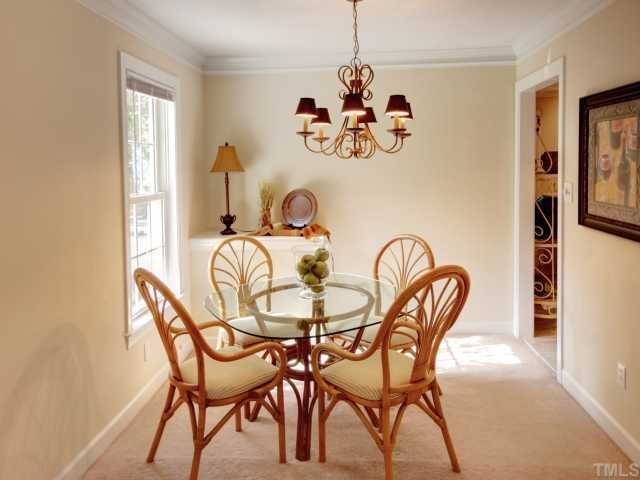 6625 Coach Light Circle Raleigh, NC 27613 - Photo 3 of 12 Dining area is right off the kitchen and is open to the living room which allows for expandable dining seating. Perfect for Holiday gatherings!