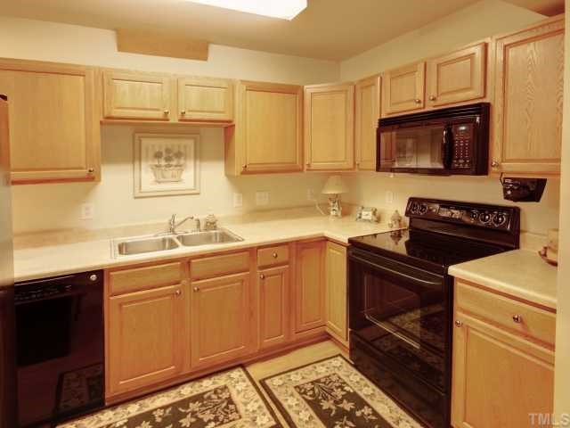 6625 Coach Light Circle Raleigh, NC 27613 - Photo 10 of 12 Basement kitchenette with double sink, smooth top stove, built in microwave.
